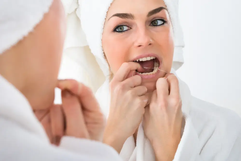 woman-flossing-her-teeth