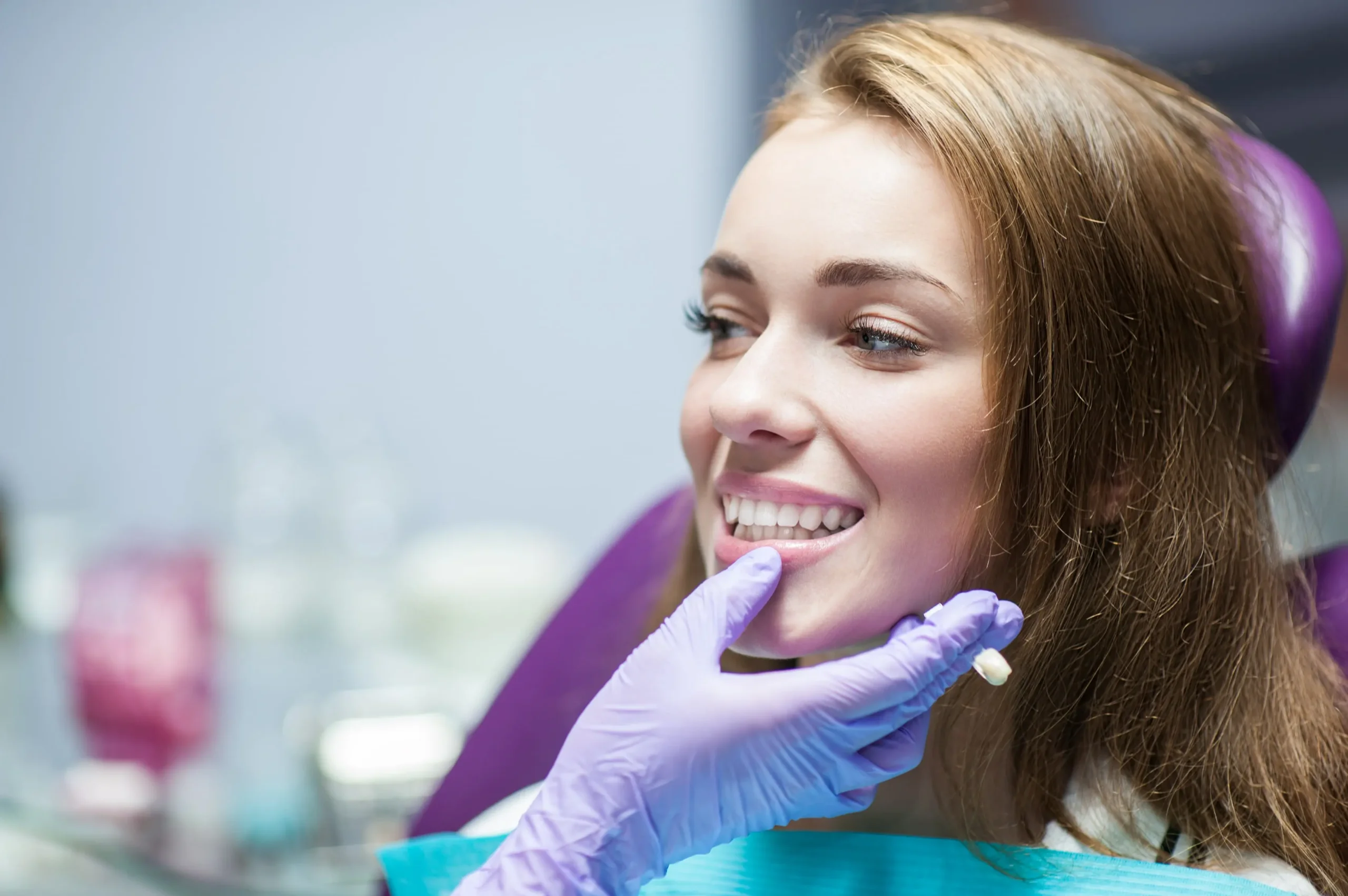 A young woman at the dentist getting her teeth checked